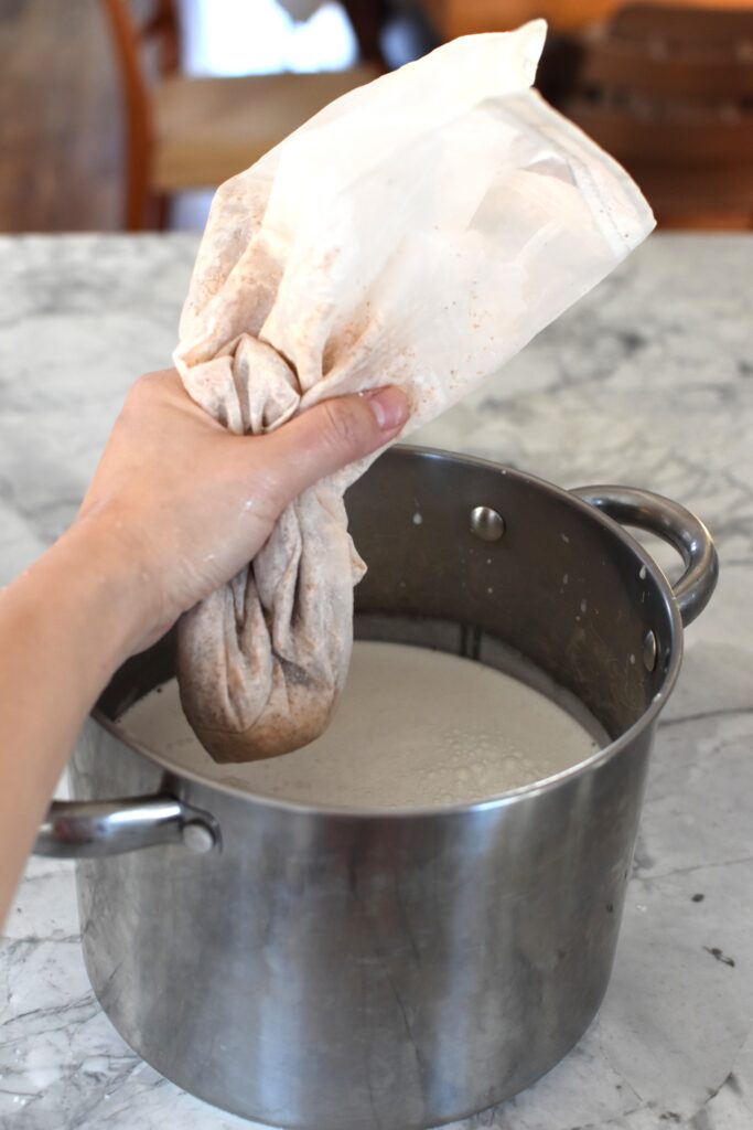 straining almond milk with dates in nut milk bag