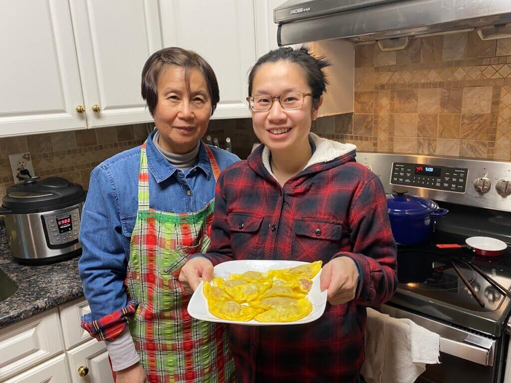 mom and bernice in kitchen holding dumplings