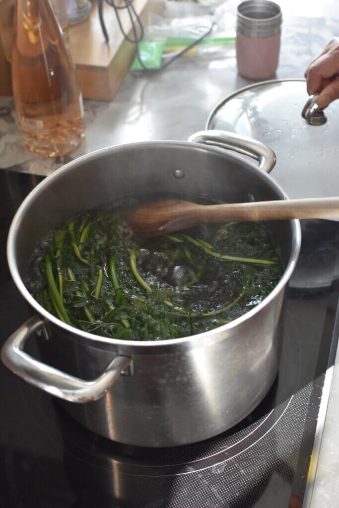 Boiling dandelions in a large stock pot