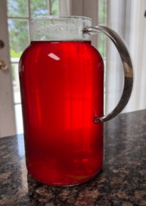 a pitcher of pink/red shiso tea