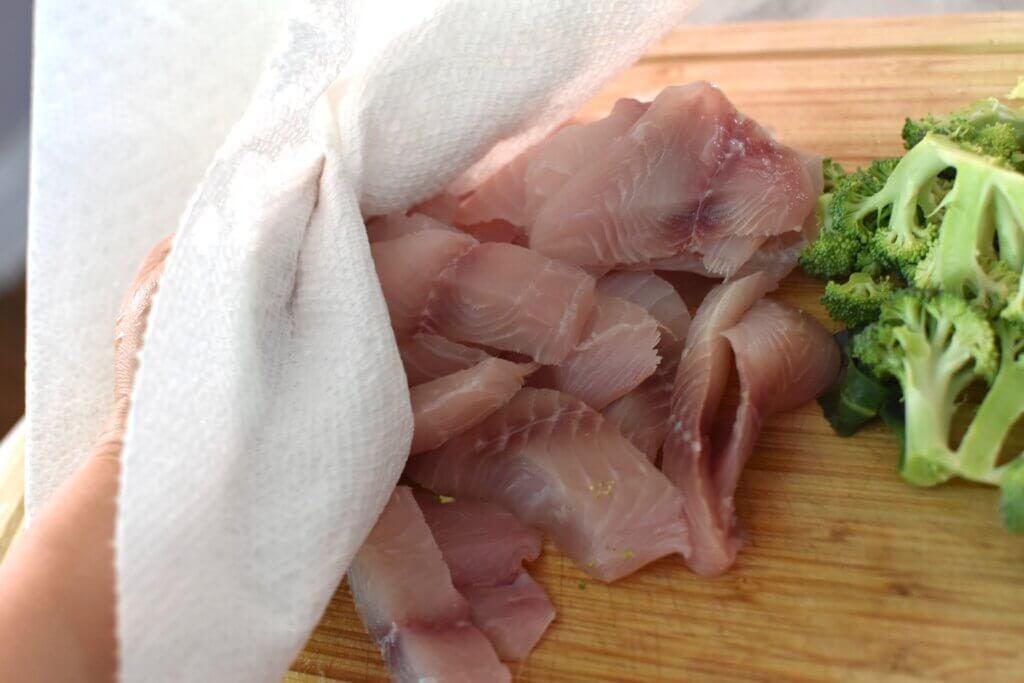 patting fish dry